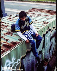 a man sitting on top of a shipping container