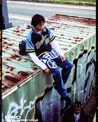 a man sitting on top of a container